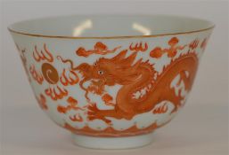 QIANLONG: A small tea bowl decorated with dragons.