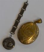 A large oval gilt locket together with a silver sp