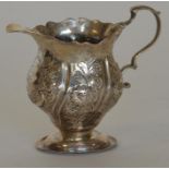 A Georgian small helmet shaped cream jug decorated