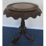 An Antique hardwood carved pedestal table on sweep