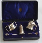 An unusual boxed three piece cruet with hinged top
