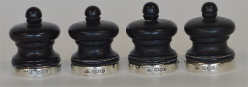 A set of four silver banded and ebony peppers. Lon