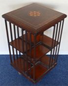 A revolving bookcase with shell inlay. Est. £60 -