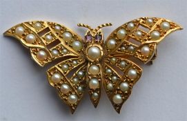 An attractive 9 carat pearl and red stone brooch i