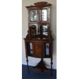 An attractive rosewood inlaid corner cupboard with