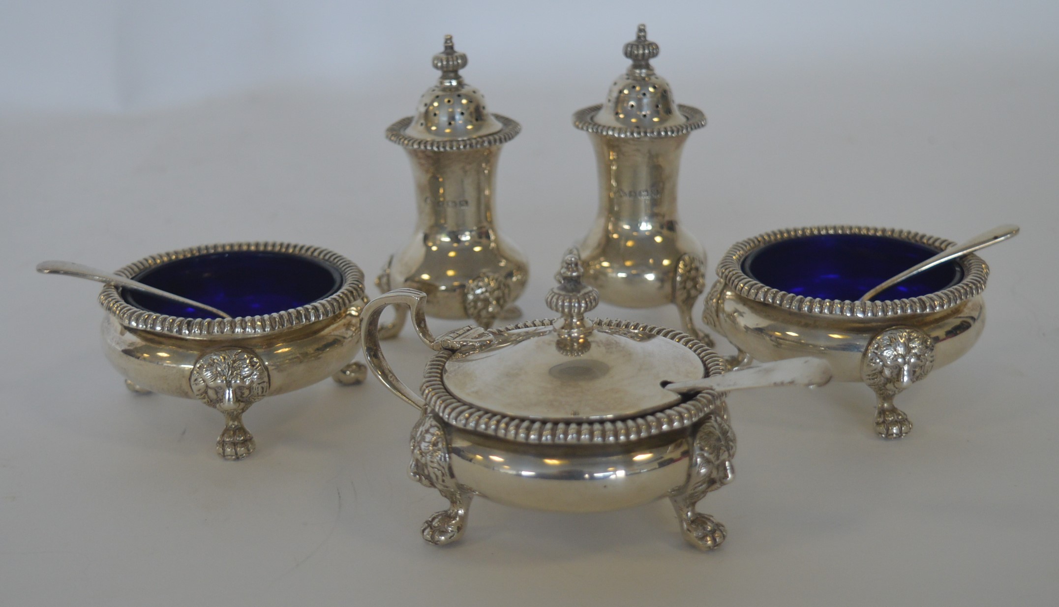 A heavy silver five piece cruet with gadroon rim a