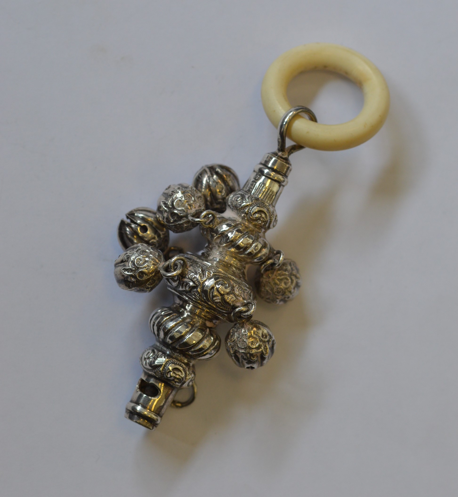 A Georgian silver baby's rattle and teether. Est.