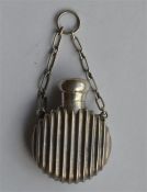 A small reeded scent bottle on suspension chain wi