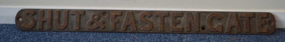 A cast iron "Shut and Fasten Gate" sign. Approx. 8