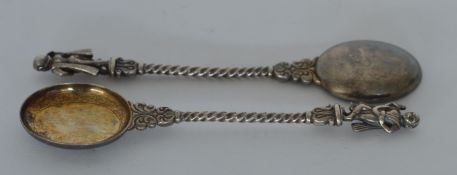 A pair of cast Indian spoons with swirl decoration