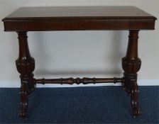 An attractive rosewood hall table with stretcher b