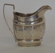A large helmet shaped cream jug decorated with flo