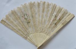 A carved ivory and lace fan. Est. £20 - £30.