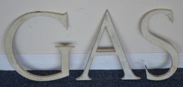Three cast metal letters, "G", "A" and "S". Each a