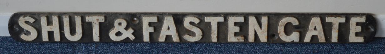 A cast iron "Shut and Fasten Gate" sign. Approx. 8