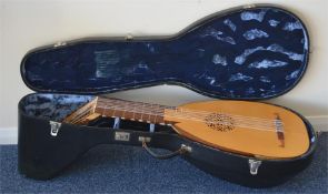 A two colour wooden oud in fitted travelling case,