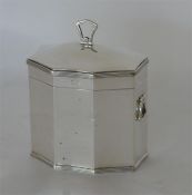 An octagonal hinged top tea caddy with gilded inte
