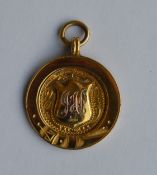 A small gold medallion with loop top. Approx. 4.8
