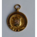 A small gold medallion with loop top. Approx. 4.8