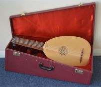 A two colour wooden oud in fitted travelling case,