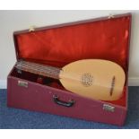 A two colour wooden oud in fitted travelling case,