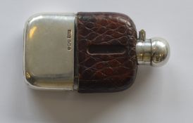 A silver mounted and leather hip flask with hinged