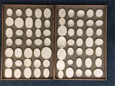 35 oval intaglios displayed upon two wooden trays.