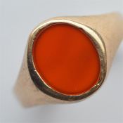 A 9 carat oval signet ring inset with cornelian. A