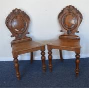 A pair of oak shield back hall chairs. Est. £30 -