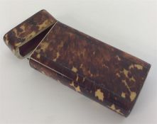 A tortoiseshell spectacle case with hinged top and