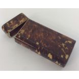 A tortoiseshell spectacle case with hinged top and