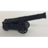 A good heavy cast iron canon. Approx. 30 cms long.