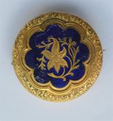 A circular gold and enamel brooch with engine turn