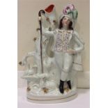 A tall Staffordshire figure of a hunter and dogs.