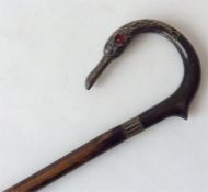 An unusual walking cane mounted with a silver swan