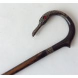 An unusual walking cane mounted with a silver swan