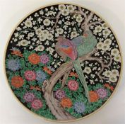 A large Japanese circular charger decorated with flowers an