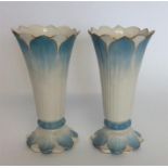 A pair of blue and white vases with gold decoratio