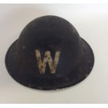 An old World War II warden's helmet. Est. £10 - £15.