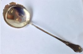 A large Continental silver gilt serving spoon, the