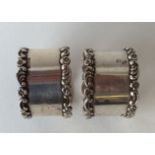 A pair of heavy scroll decorated napkin rings. Bir