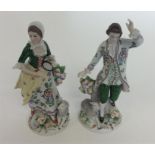 A pair of Continental green decorated figures moun