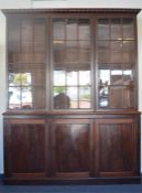 An impressive mahogany three door bookcase with pa