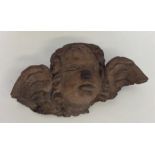 An unusual carving of a winged infant. Est. £15 -