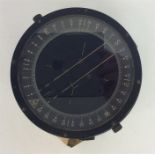 An old World War II compass. Est. £40 - £60.
