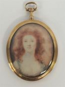 An oval miniature on ivory of a lady in gold frame