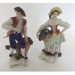 A pair of Continental figures of grape pickers on