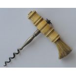 A turned Antique corkscrew with brush to side and