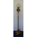 A tall heavy brass and copper mounted oil lamp wit