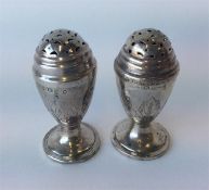 A pair of Georgian peppers on pedestal base with e